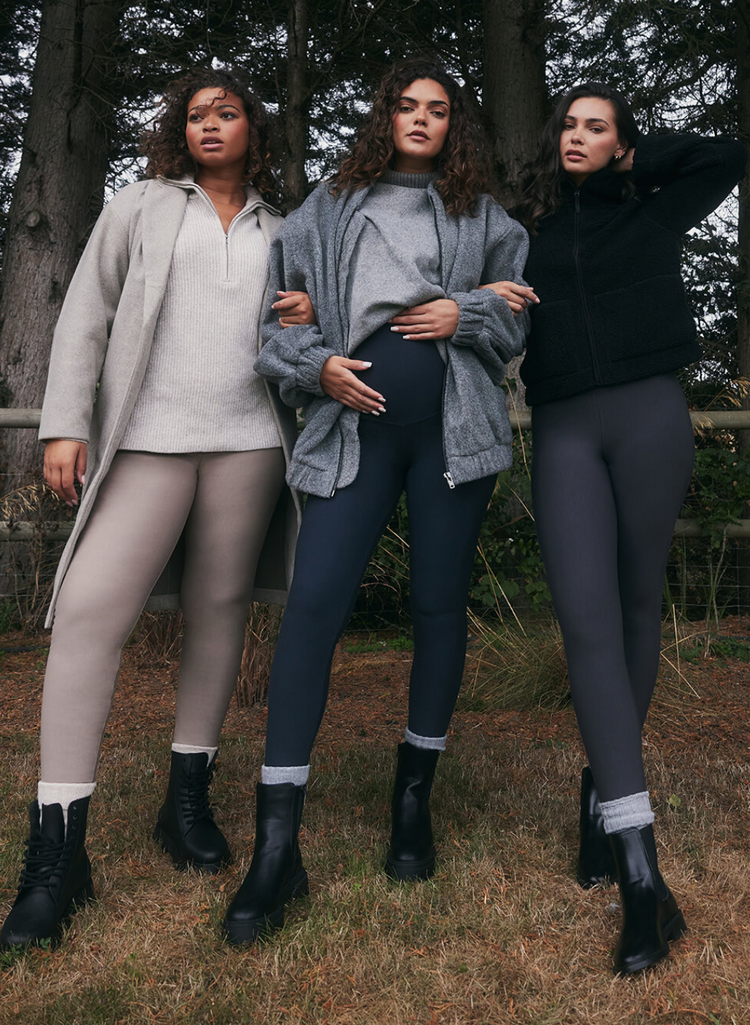 Three models wearing Everyday Winter Leggings and Extreme Fleece Lined Leggings from LOVALL. They are outside, in the woods and wrapped up in layers of warm clothing.